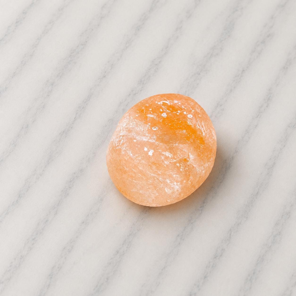 Himalayan Salt Massage Stone Oval smooth pink surface in hand