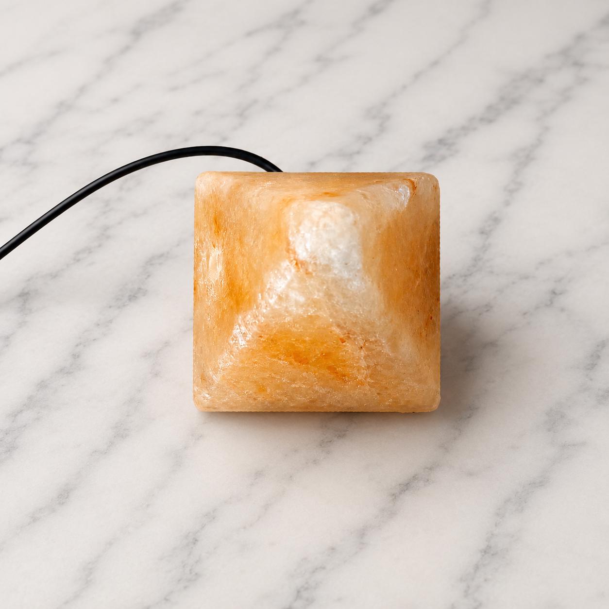 Mini Pyramid Himalayan Salt Lamp USB glowing pink on a desk