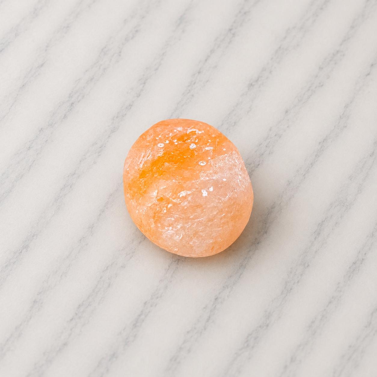 Himalayan Salt Massage Stone Oval smooth pink surface in hand