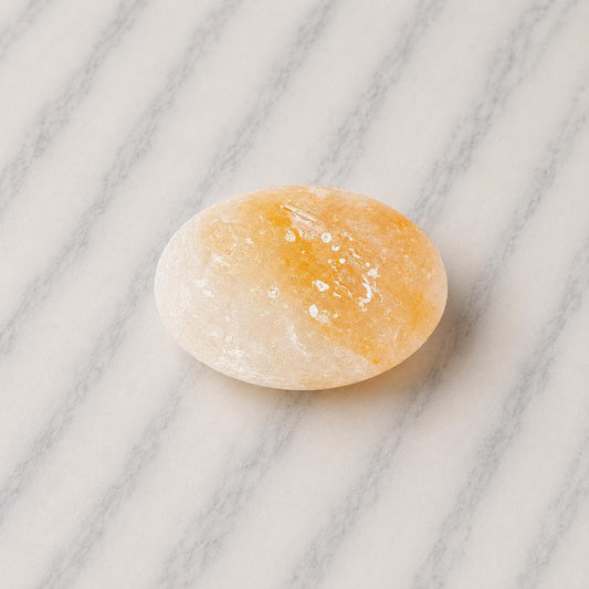 Himalayan Salt Massage Stone Oval smooth pink surface in hand
