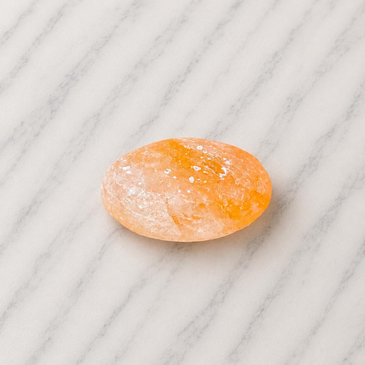 Himalayan Salt Massage Stone Oval smooth pink surface in hand