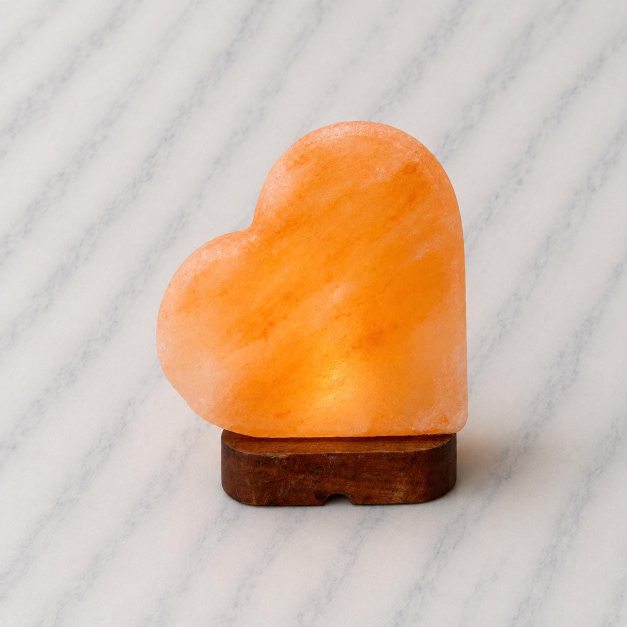 Heart Himalayan Pink Salt Lamp glowing warm pink light in home setting