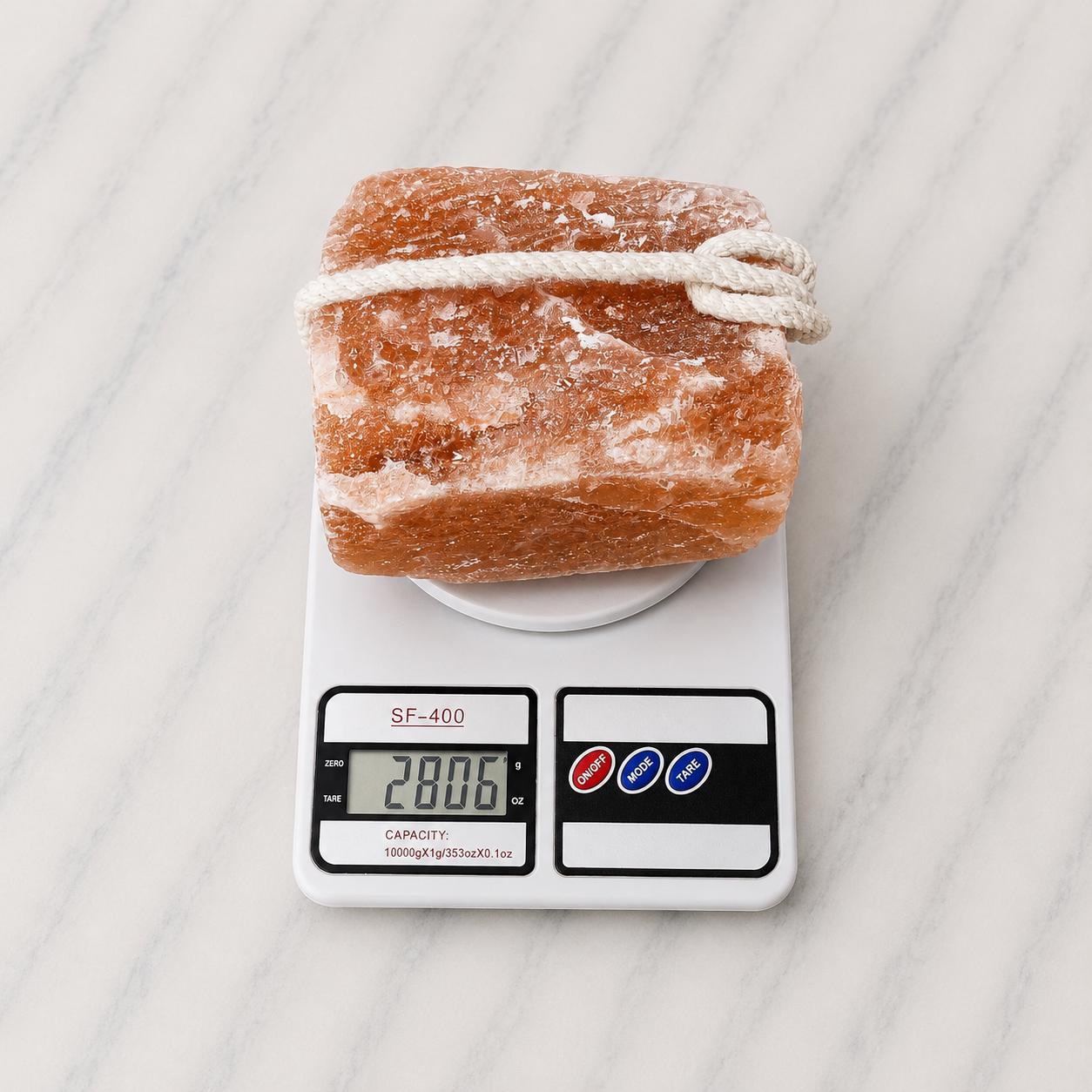 Himalayan Salt Licking Block with rope hanging in a horse stall