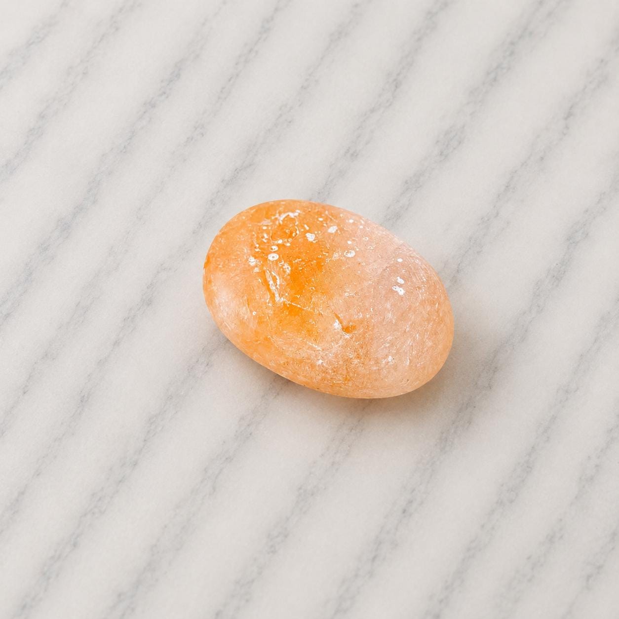 Himalayan Salt Massage Stone Oval smooth pink surface in hand
